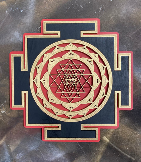 Red and gold Sri Yantra centered on a black square base